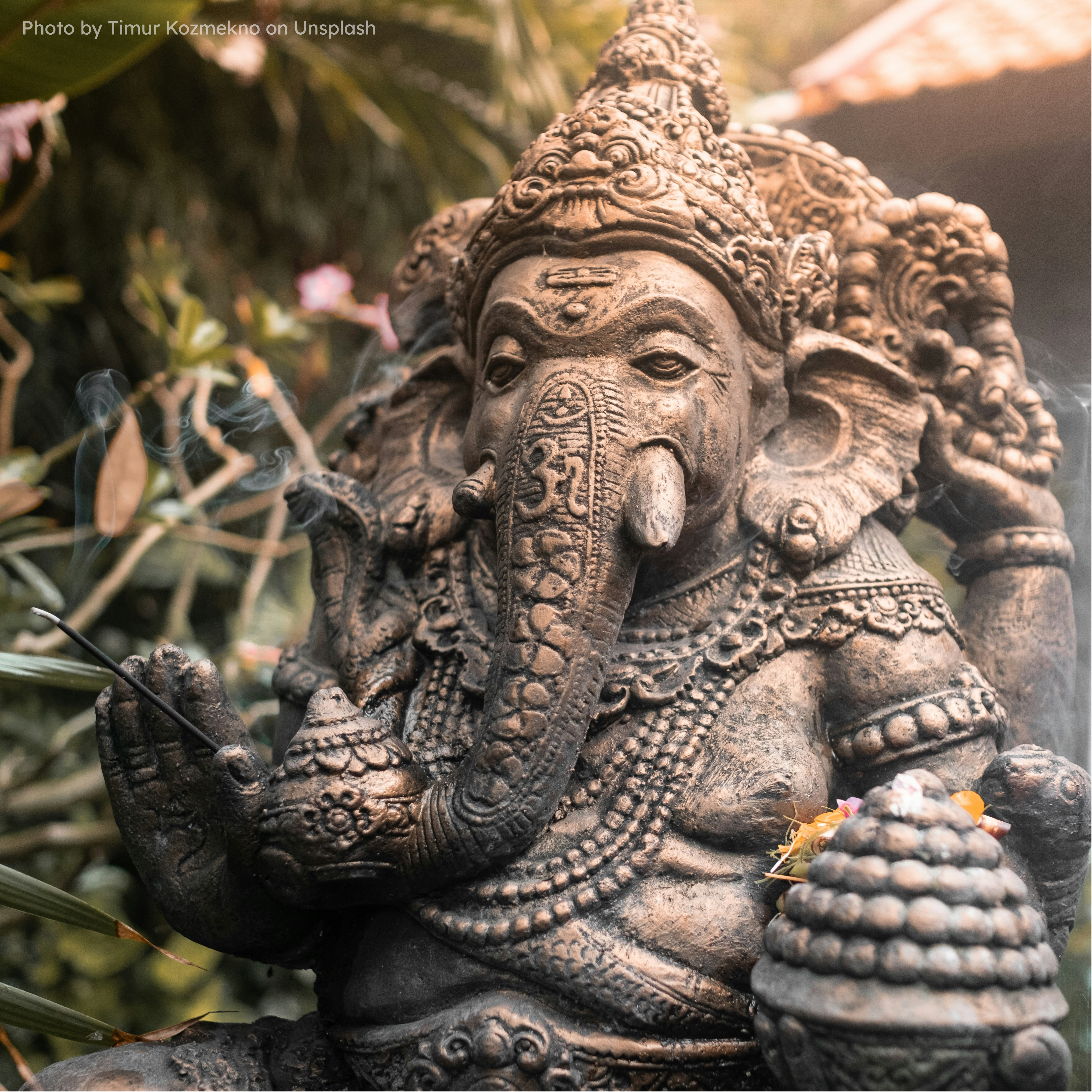 Ganesha statue made in Balinese sculpture art in traditional style of Ganesha giving boon with one hand, and in one hand laddoo.